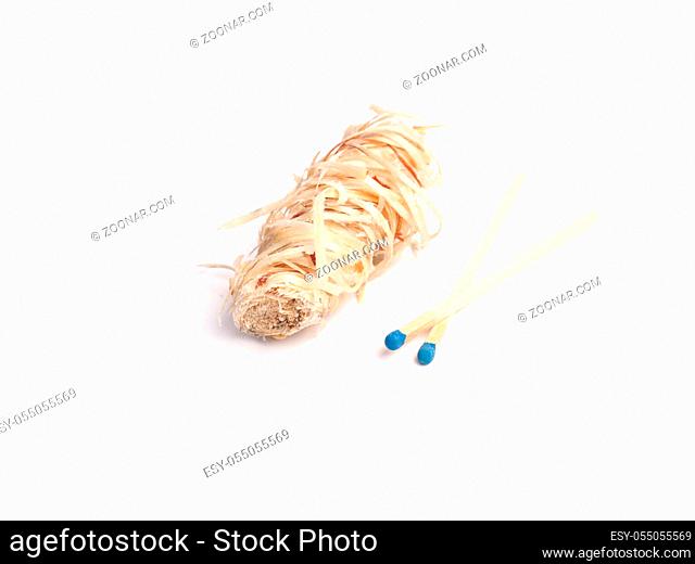Fireplace igniter with matches on a white studio background