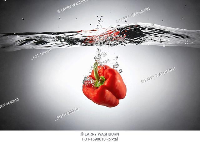 Close-up of red bell pepper in splashing water