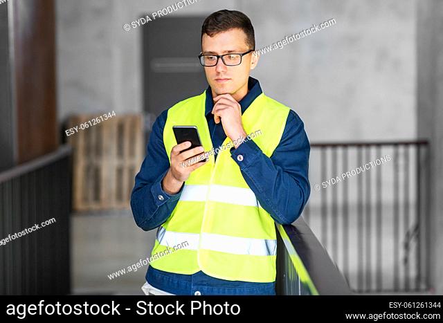 male architect with smartphone at office