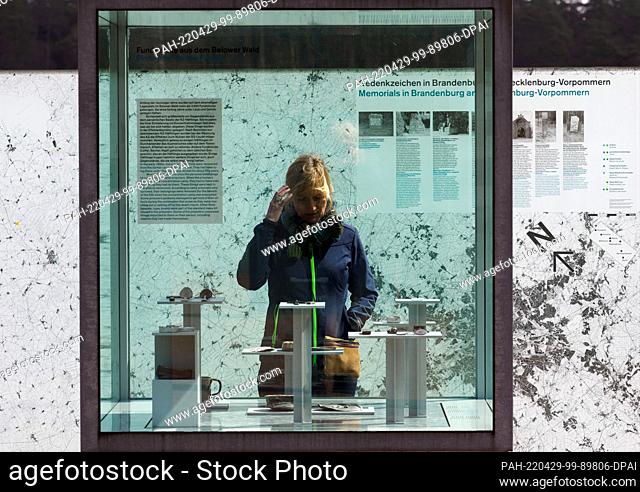 27 April 2022, Brandenburg, Wittstock/Dosse: A woman visits the open-air exhibition on the grounds of the Belower Wald memorial