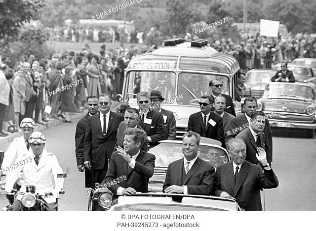 US president John F. Kennedy on 26 June 1963 in Berlin in the open Lincoln limousine with mayor Willy Brandt (M) and german chancellor Konrad Adenauer (r)