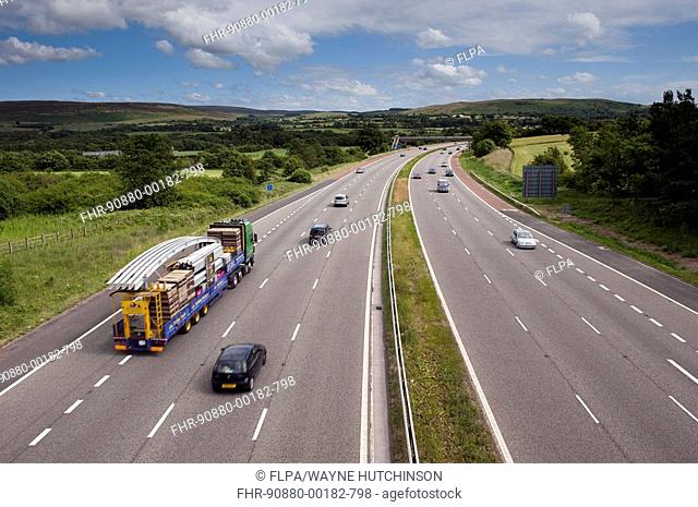 Traffic on motorway running through countryside, M6 Motorway, near Forton Services, Lancaster, Lancashire, England, july