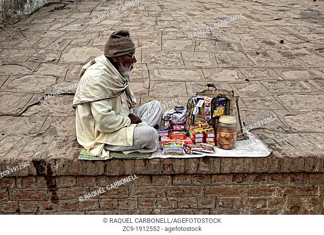 Elder man selling snacks in a ghat of Varanasi  Benares, Uttar Pradesh, India