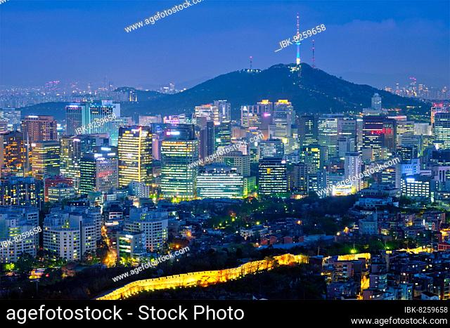 Seoul downtown cityscape illuminated with lights and Namsan Seoul Tower in the evening view from Inwang mountain. Seoul, South Korea, Asia