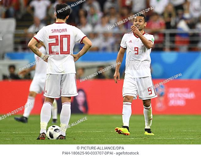 25 June 2018,  Russia, Saransk: Soccer: FIFA World Cup 2018, Iran vs Portugal, group stages, group B, 3rd matchday: Iran's Sardar Azmoun (L) and Omid Ebrahimi...