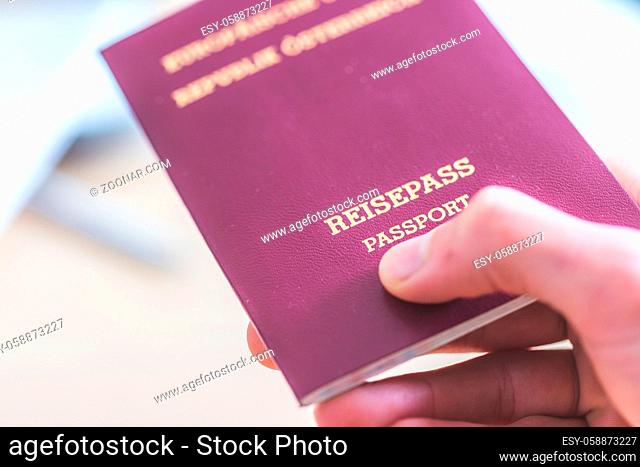Close up of fingers holding a passport for travelling, airport, ?Reisepass Passport?