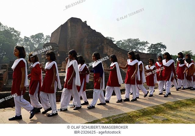 Indian pupils visiting an archaeological site and an important Buddhist pilgrimage destination, ruins of the ancient University of Nalanda, Ragir, Bihar, India