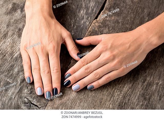 Beautiful hands with the miniature painted in a gray-colored
