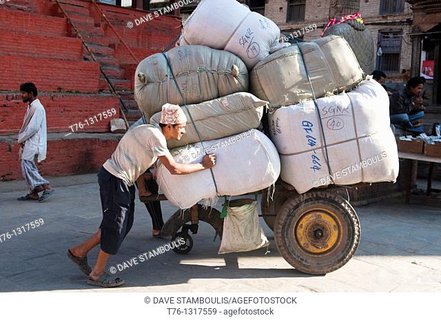 a porter and his load in Durbar Square in Kathmandu, Nepal