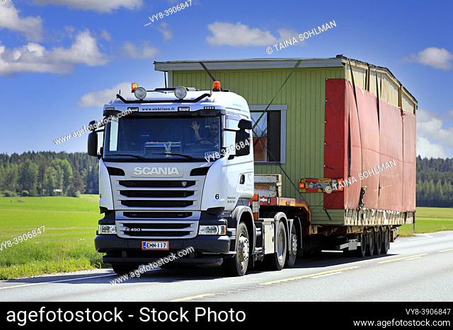 Silver Scania R490 truck semi trailer Nosto ja Kuljetus S. Lehtinen Oy hauls portable cabin as exceptional load. Jokioinen, Finland. June 15, 2020
