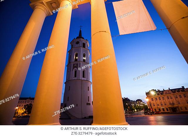 Night view of Vilnius Belfry (Bell Tower) framed through the portico columns of the Cathedral Basilica of St. Stanislaus and St. Ladislaus