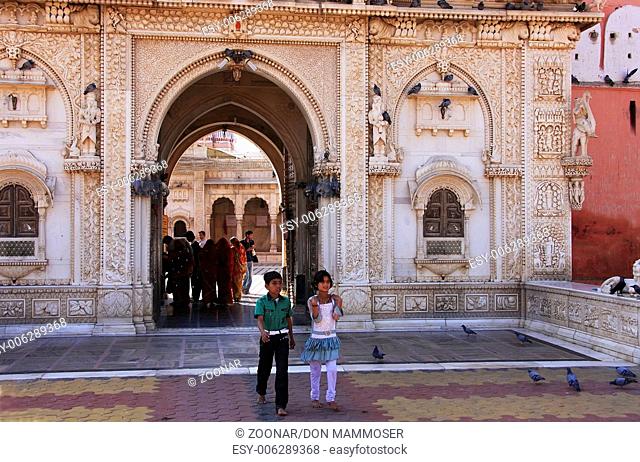 Indian boy and girl going out of Karni Mata Temple
