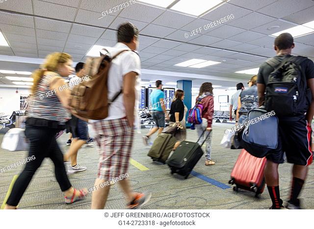 Florida, Miami, Miami International Airport, MIA, aviation, terminal, concourse, gate, passenger, traveler, man, woman, luggage, walking, casual clothes, motion