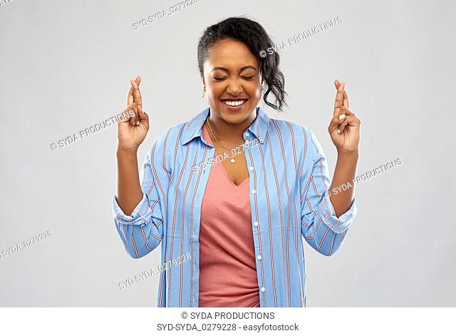 african american woman holding fingers crossed