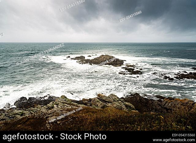 Scenic view of cliffs and sea against cloudy sky. Pointe Saint Mathieu, Brittany, France