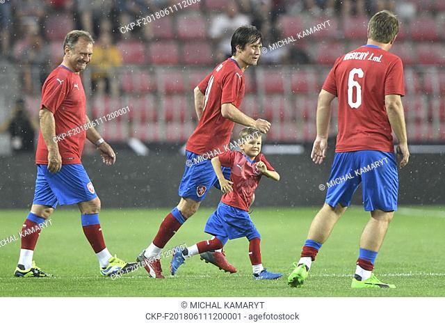Tomas Rosicky and his son Tomas Rosicky Jr and father Jiri, left, and brother Jiri Jr, right, of Czech team enter the pitch in the match