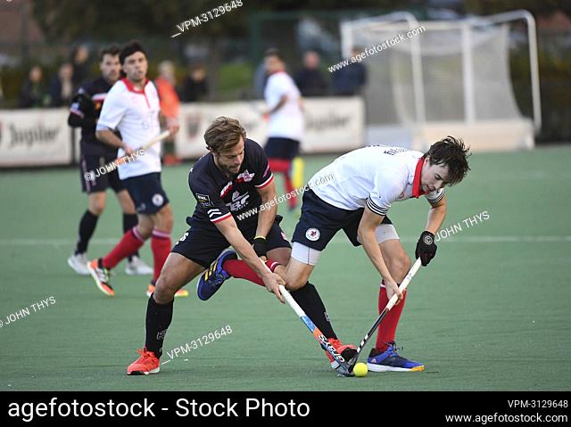 Leopolds's Maxime Plennevaux and Leuven's Sean Murray fight for the ball during a hockey between Koninklijke Hockey Club Leuven and Royal Leopold Club