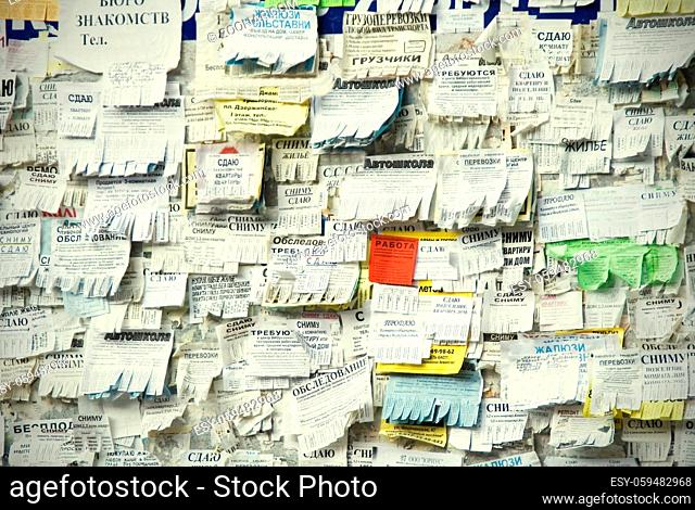 Volgograd, Russian Federation, September 23, 2009: Grunge Message Board with many advertisement