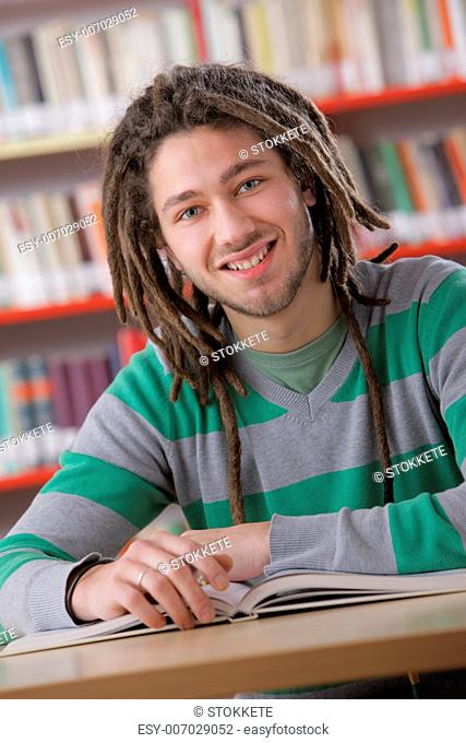Young friendly man at the library