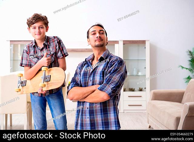 The young father repairing skateboard with his son at home