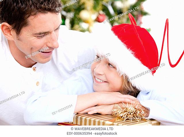 Attractive father celebrating christmas with his son at home