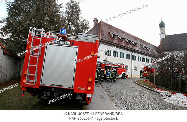 Firemen stand in front of a Franciscan monastery in Fuessen, Germany, 06 January 2013. Fire broke out early in the morning, one friar is criticaly wounded