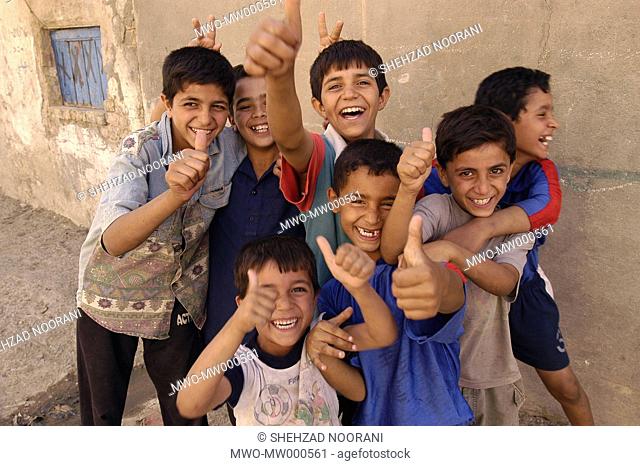 A group of young Iraqi children making victory posture that they learned from American forces that took over Iraq recently Zafrania district Baghdad Iraq