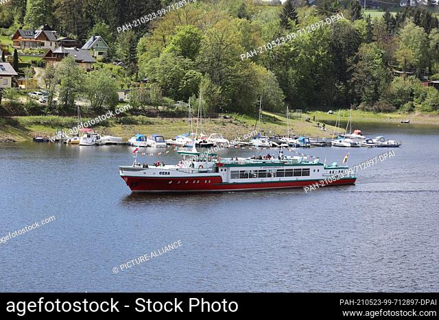 23 May 2021, Thuringia, Saalburg: The passenger ship ""MS Gera"" sails across the Bleiloch dam with passengers on board. Visitors take advantage of the...