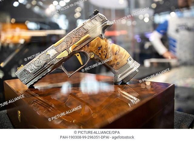 08 March 2019, Bavaria, Nürnberg: The hand-engraved and gold-plated Q5 Match Steel Frame handgun from German weapons manufacturer Walther will be on display at...