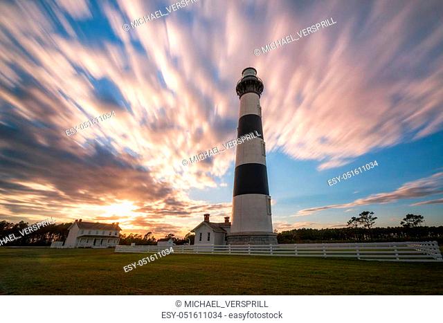 Clouds passing over Bodie Island Lighthouse at sunset