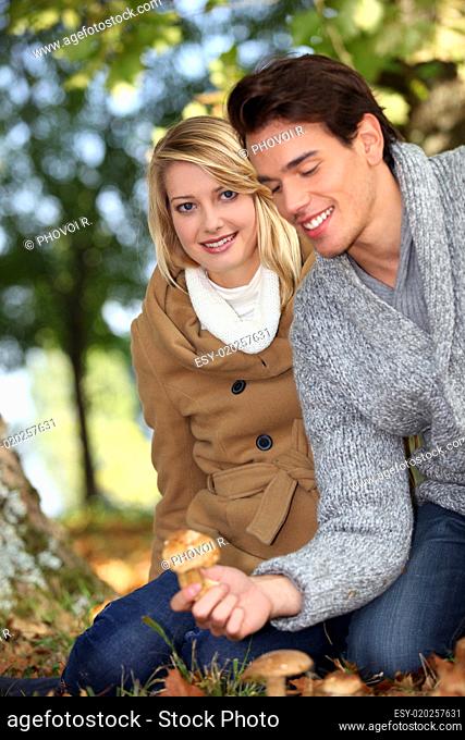 Couple picking mushrooms together