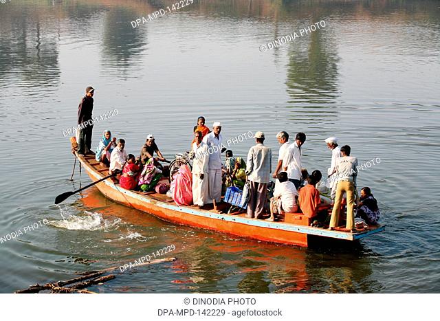 Villagers of the Haripur village loading their bicycles on a boat  ; Sangli district ; Maharashtra ; India