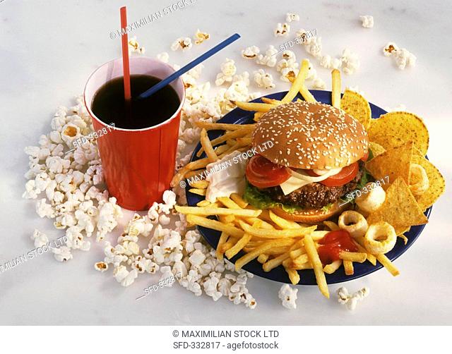 Unhealthy food: burger, chips, popcorn, cola, crisps