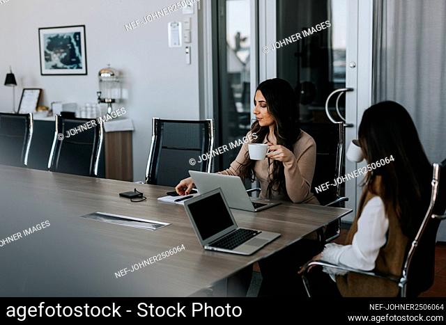 Female coworkers in boardroom