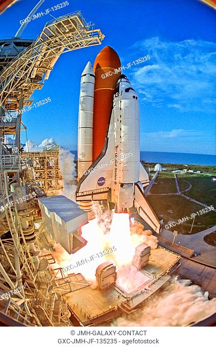 Captured with a remote camera equipped with a special fish-eye lens, the Space Shuttle Atlantis and its seven-member STS-117 crew head toward Earth-orbit and a...