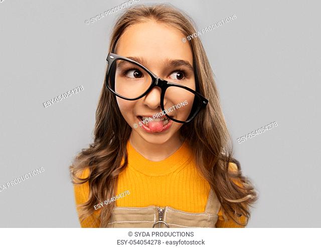 smiling teenage student girl in glasses