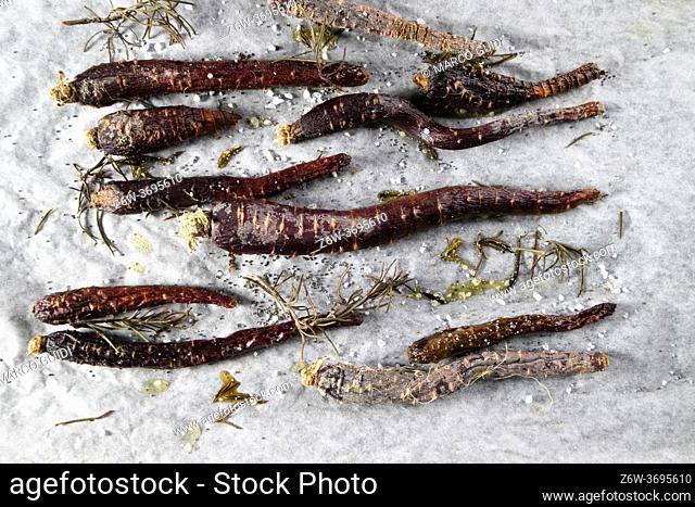 Photo shoot of a plate of baked purple carrots