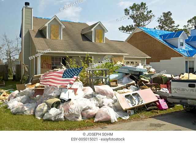 American flag and debris in front of house heavily hit by Hurricane Ivan in Pensacola Florida