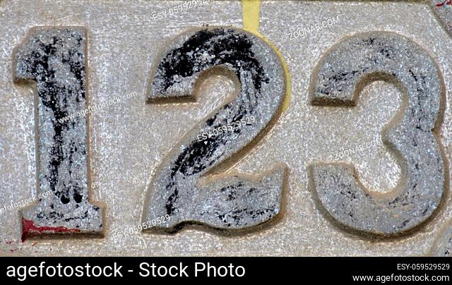 Vintage grunge square metal rusty plate of number of street address with number. Close up, brand. 123