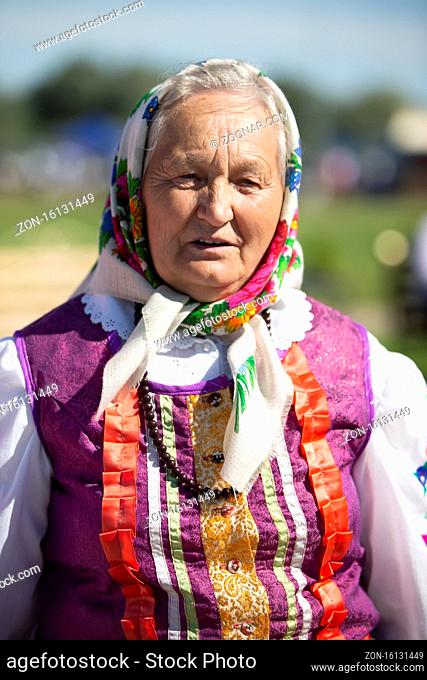 08/29/2020 Belarus, Lyakhovichi. City festival. Old Slavic woman in national dress. Russian granny in a scarf
