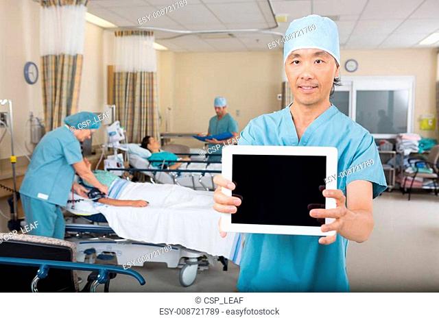 Male Nurse Showing Digital Tablet In Hospital Ward