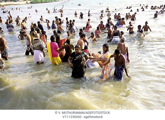 Devotees taking a dip in the holy waters of Agni Tirtha , Rameswaram, Tamil Nadu  One of the most venerated and sacred temple towns of India