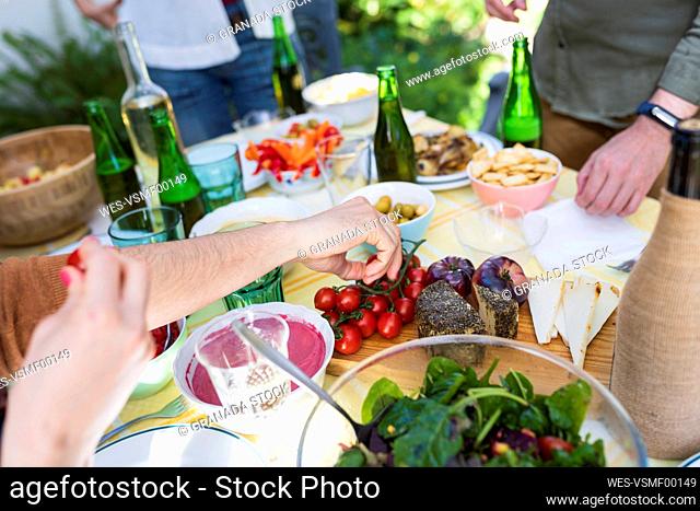 Close-up of friends enjoying healthy lunch outdoors