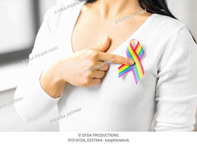 woman with gay pride awareness ribbon on her chest