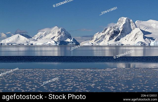 mountains and islands of the Antarctic Peninsula in winter sunny day