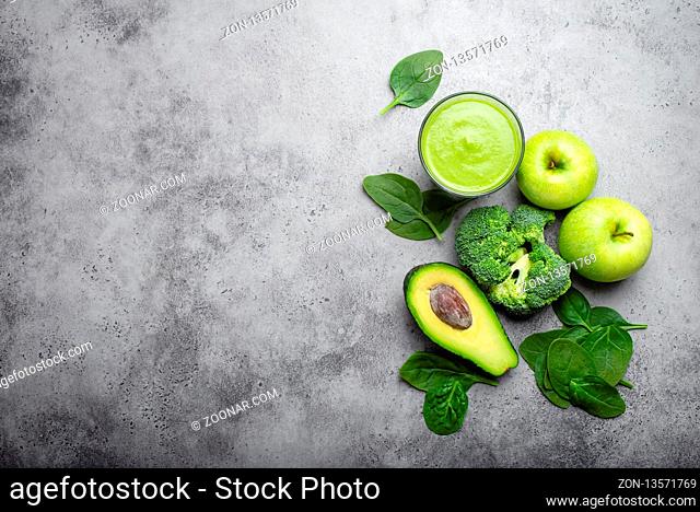 Ingredients for making green healthy smoothie with broccoli, apples, avocado, spinach, stone background. Clean eating, detox plan, diet, weight loss concept