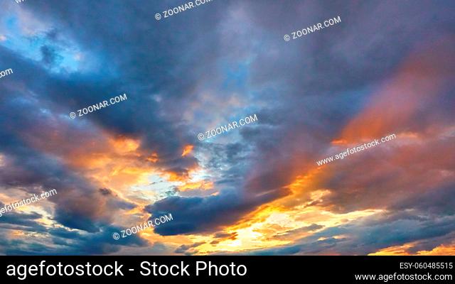 Sky with clouds of different colours at sunset, may be used as background
