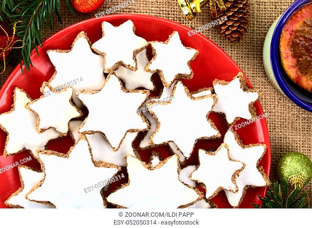 Traditional German Zimtsterne (cinnamon stars) Christmas cookies made of ground almonds, cinnamon, egg white and confectioner's sugar, meringue on top