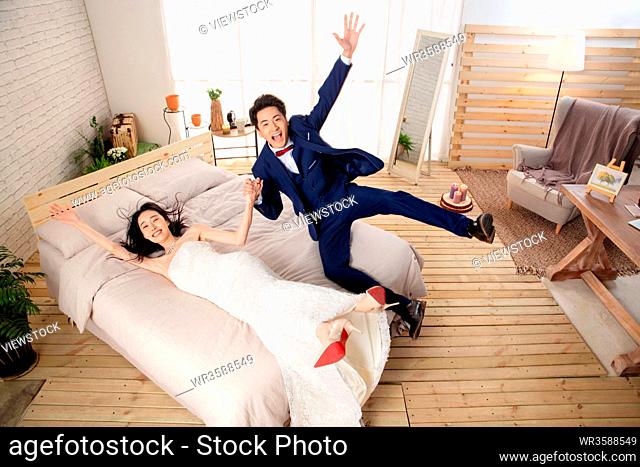 The excitement of newlyweds fell back on the bed