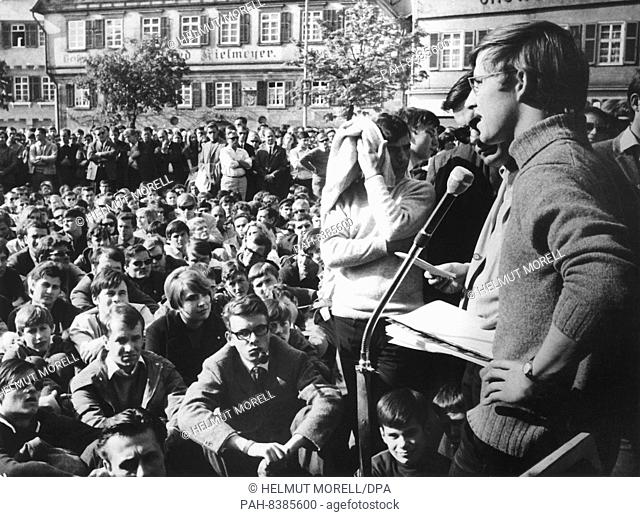 The chairman of the Socialist German Student Union (SDS) Frank Wolff (r) speaks in April 1968 about the participants of the ""Teach in"" at the town hall square...